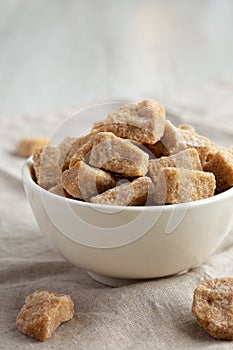 Raw Organic Demerara Granulated Brown Sugar in a Bowl, side view. Close-up