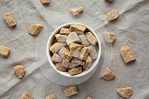 Raw Organic Demerara Granulated Brown Sugar in a Bowl, top view. Flat lay, overhead, from above