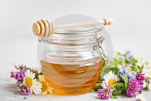 Raw organic honey jar with flowers