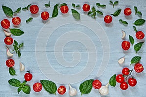 Raw organic ingredients for caprese salad or healthy vegetarian diet dish. Cherry tomatoes, fresh basil leaves, garlic