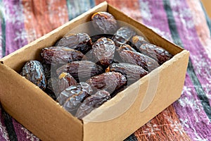 Raw and organic Medjool date fruit in paper box package