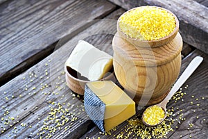 Raw organic polenta corn meal in a wooden bowl