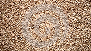 Raw organic quinoa grains on rotating background. Seeds texture. Food ingredient background. Top view, healthy lifestyle