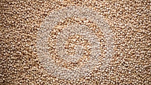 Raw organic quinoa grains on rotating background. Seeds texture. Food ingredient background. Top view, healthy lifestyle