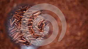 Raw organic rice berry, brown rice mixed texture on rotating background. Food ingredient concept. Top view, healthy