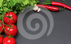 Raw organic vegetables with fresh ingredients for healthily cooking on dark vintage background, top view. Vegan or diet food