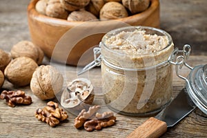 Raw organic walnut butter and fresh nuts. photo