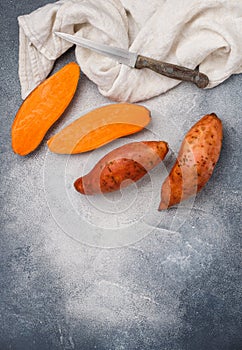 Raw organic whole and sliced sweet potatoes