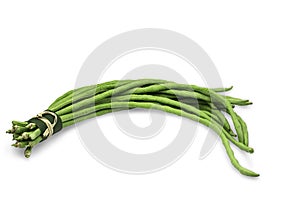 Raw organic yard long bean in rustic bundle on white isolated background with clipping path. Fresh yard long bean have sweet taste