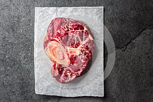 Raw osso buco veal shank on slate background. Top view photo