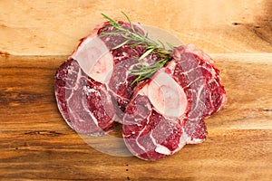 Raw osso buco on a wooden kitchen board photo