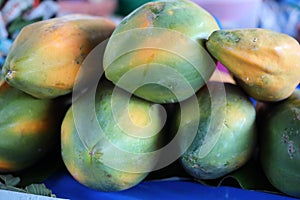 Raw papaya has green color. When cooked, the meat will be yellow to orange. Popularly eaten both fresh and cooked