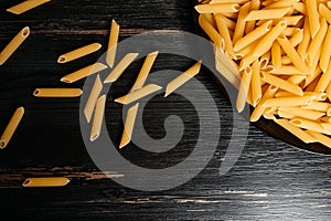 raw pasta in a black plate on a black table