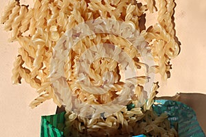 Raw pasta on a bodily background