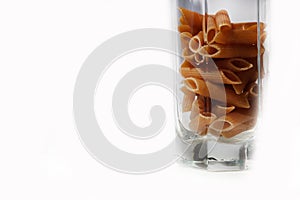 Raw pasta in a clear glass