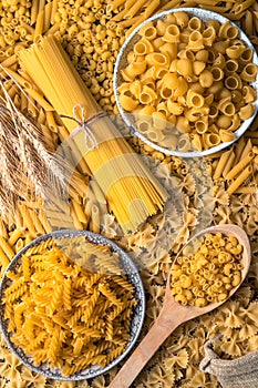 Raw pasta of different types on the table.