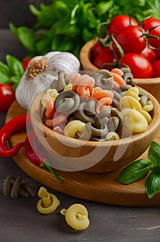 Raw pasta with fresh cherry tomatoes, basil, chili pepper and garlic for Italian food.