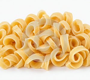 Raw pasta Fusilli in bow, cut out on white background