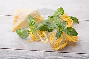 Raw pasta, green basil and chesse