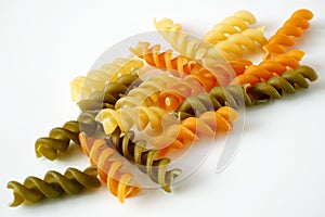 Raw pasta set, background different spirals with eggs, spinach and romato on white background, closeup