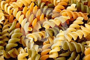 Raw pasta set, background different spirals with eggs, spinach and romato on white background, closeup