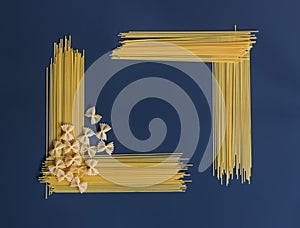 Raw pasta spaghetti and farfalle in shape of frame