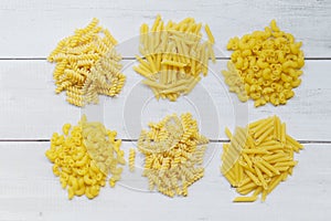 Raw pasta various kinds of uncooked pasta macaroni spaghetti and noodles - top view, Italian food culinary concept, Collection of