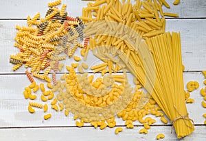 Raw pasta various kinds of uncooked pasta macaroni spaghetti and noodles on wooden, Italian food culinary concept, Collection of