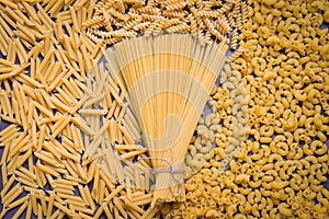 Raw pasta various kinds of uncooked pasta macaroni spaghetti and noodles on wooden, Italian food culinary concept, Collection of