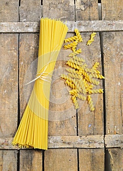 Raw pasta on wooden background