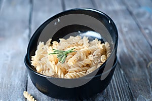 Raw pasta on wooden background