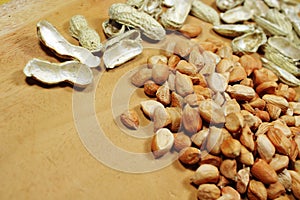 Raw Peanut Kernels and Empty Peanut Shells on Wooden Table