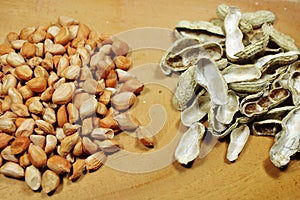 Raw Peanut Kernels and Empty Peanut Shells on Wooden Table