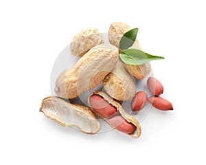 Raw peanuts and leaves on white background, top view