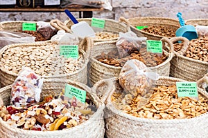Raw peeled almonds, dried tropical fruits, raw almonds with skin and fried salted broad beans at Sineu market photo
