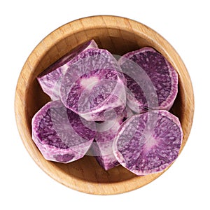 Raw peeled purple potatoes in wooden bowl isolated on white background. Top view