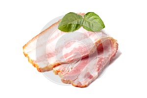 Raw piece of fresh bacon with basil leaf green isolated on a white background