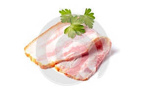 Raw piece of fresh bacon with parsley leaf green isolated on a white background