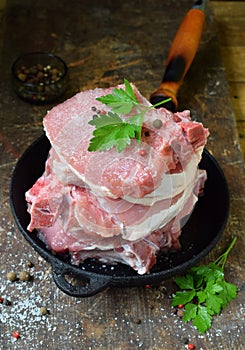 Raw piece meat of pork and spices marinade on wooden background. For steak, roasting, stewing. Space for text