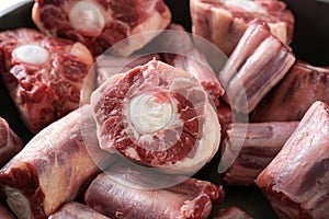 Raw pieces of oxtail with bone, gelatin-rich meat, usually slow-cooked as a stew or braised, traditional stock base for oxtail