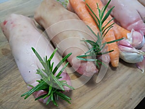 Raw pigs trotter with carrots and herbs