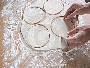 Raw pirozhki with cabbage in the cooking process.