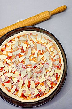 Raw pizza prepared for baking. View from above.