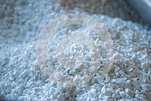 Raw plastic material white granules in metal box