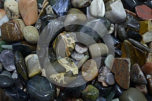 Raw but polished pieces of semi-precious natural stones - jaspers, agates, nephritis