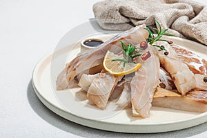 Raw pollock (Pollachius virens) fillet. Fresh fish for healthy food lifestyle. Spices and herbs