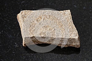 raw polymictic sandstone stone on dark