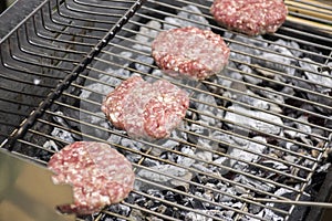 Raw pork and beef meat prepared for hamburgers on barbecue grill treatment