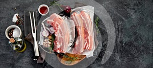 Raw pork belly on dark gray background. Organic gourmet food concept