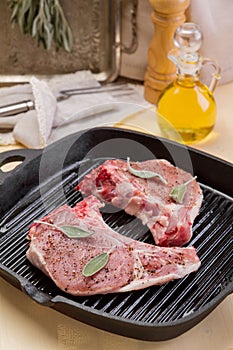 Raw pork with bone at the grill frying pan